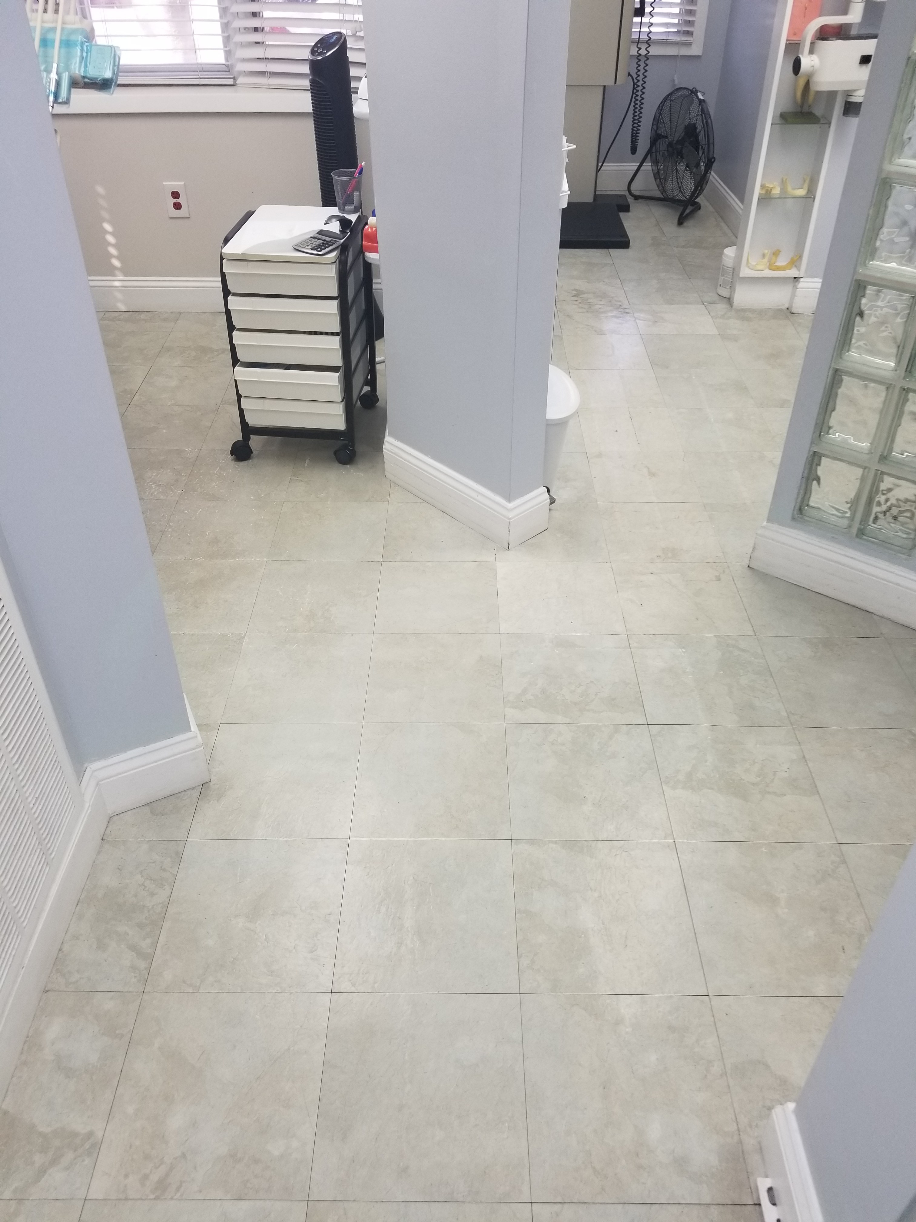 Dental office renovation: light stone-look floor tile through the treatment rooms