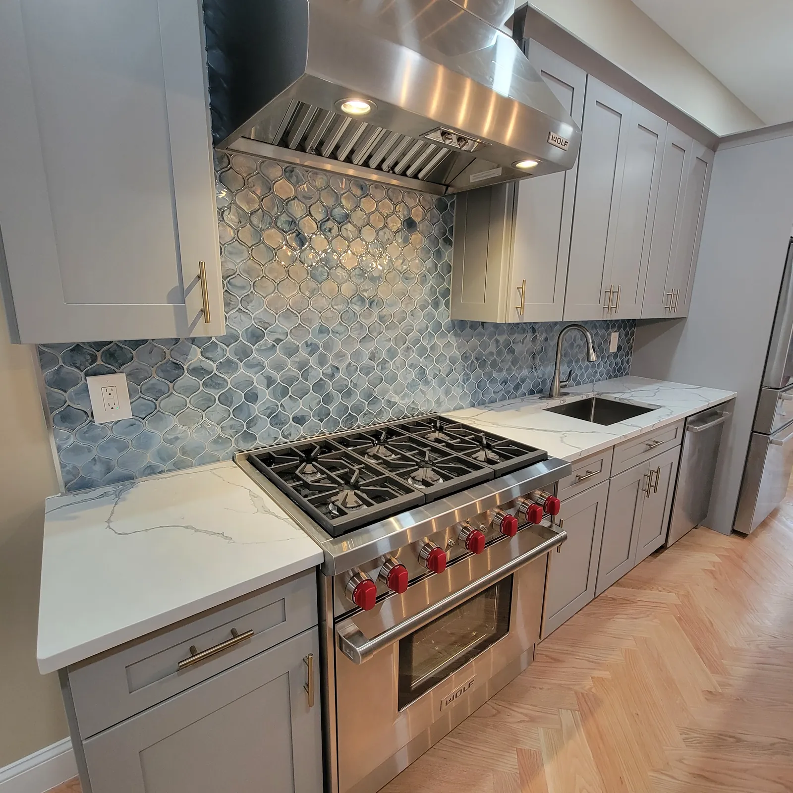 Kitchen remodel in the Bronx, NY: gray shaker cabinets, blue arabesque mosaic backsplash and a stainless range