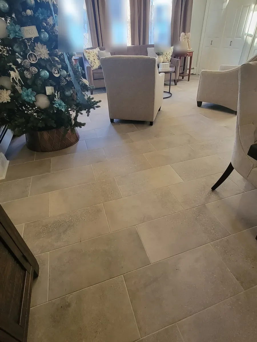Living room remodel in Levittown, NY: large floor tiles running into the seating area